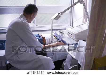 Doctor examining a patient View Large Photo Image Picture - Doctor examining a patient. Fotosearch