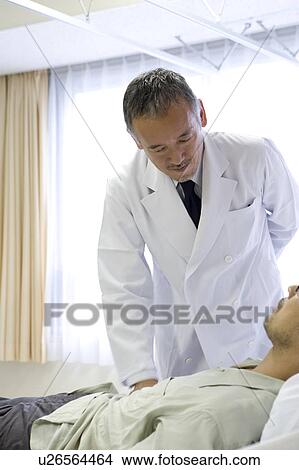 Picture - Doctor examining a patient. Fotosearch
