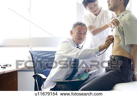 Doctor examining patient with stethoscope View Large Photo Image Picture - Doctor examining patient with stethoscope. Fotosearch
