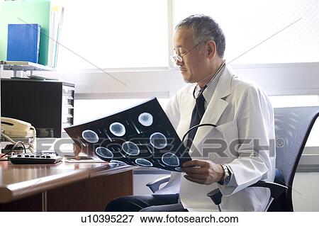 Doctor examining X-ray image View Large Photo Image Stock Photo - Doctor examining X-ray image. Fotosearch