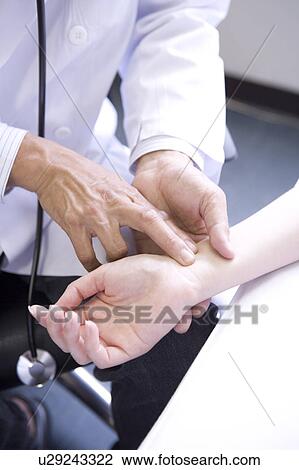 Doctor taking pulse of a patient View Large Photo Image Stock Image - Doctor taking pulse of a patient. Fotosearch