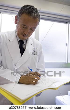 Doctor writing in chart View Large Photo Image Stock Photo - Doctor writing in chart. Fotosearch