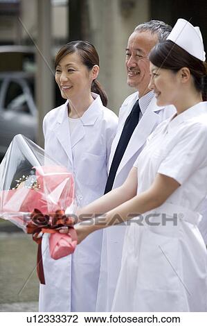 Stock Image - Doctors and nurse smiling. Fotosearch