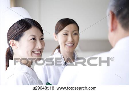 Doctors and nurse talking View Large Photo Image Stock Photo - Doctors and nurse talking. Fotosearch