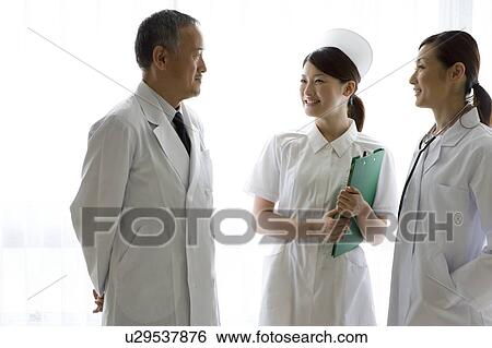 Stock Photograph - Doctors and nurse talking. Fotosearch