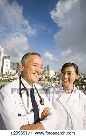 Stock Photo - Doctors talking on roof. Fotosearch