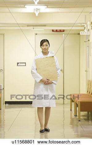 Female doctor holding X-ray image View Large Photo Image Stock Image - Female doctor holding X-ray image. Fotosearch