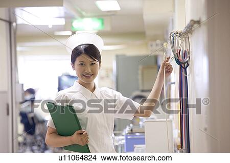 Female nurse checking stethoscopes at nurse station View Large Photo Image Picture - Female nurse checking stethoscopes at nurse station. Fotosearch