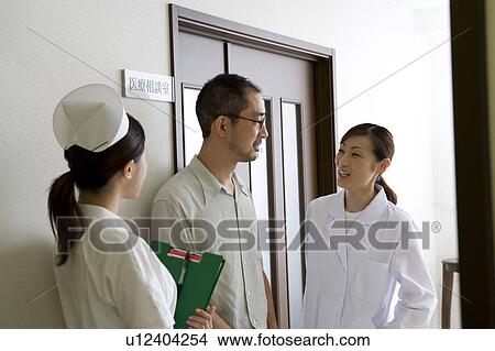 Picture - Female nurse, doctor and patient talking. Fotosearch