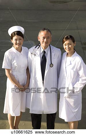 Two doctors and nurse standing View Large Photo Image Stock Photography - Two doctors and nurse standing. Fotosearch