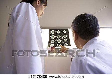 Stock Photo - Two doctors examining X-ray image. Fotosearch