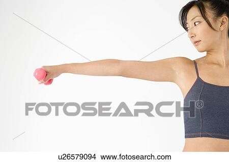 Woman exercising with dumbbell View Large Photo Image Picture - Woman exercising with dumbbell. Fotosearch