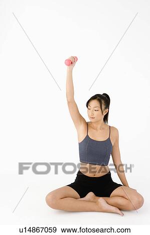 Woman exercising with dumbbell View Large Photo Image Stock Photo - Woman exercising with dumbbell. Fotosearch