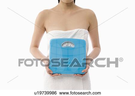 Woman holding bathroom scale View Large Photo Image Stock Photograph - Woman holding bathroom scale. Fotosearch