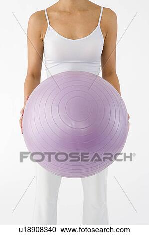 Woman holding fitness ball View Large Photo Image Stock Image - Woman holding fitness ball. Fotosearch