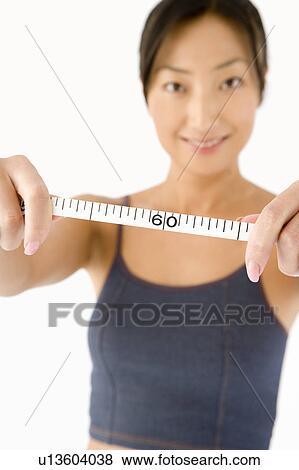 Woman holding tape measure View Large Photo Image Stock Photo - Woman holding tape measure. Fotosearch