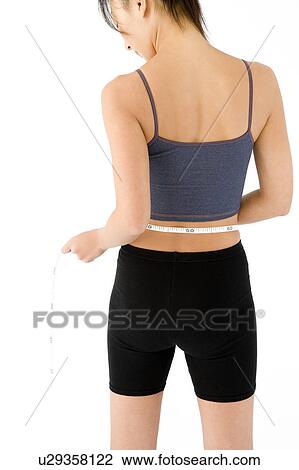 Woman measuring her waist View Large Photo Image Stock Image - Woman measuring her waist. Fotosearch
