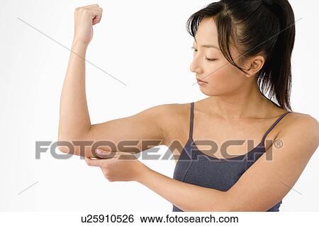 Woman pinching her arm View Large Photo Image Stock Photograph - Woman pinching her arm. Fotosearch