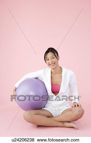 Woman sitting with fitness ball View Large Photo Image Stock Photo - Woman sitting with fitness ball. Fotosearch