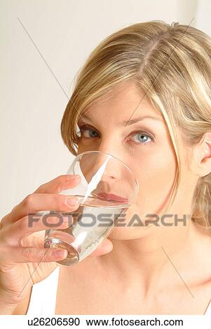 Portrait of Woman drinking mineral water View Large Photo Image Stock Image - Portrait of Woman drinking mineral water. Fotosearch