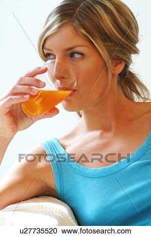 Woman drinking orange juice View Large Photo Image Stock Image - Woman drinking orange juice. Fotosearch