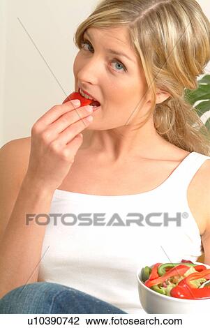 Woman eating red pepper View Large Photo Image Stock Image - Woman eating red pepper. Fotosearch