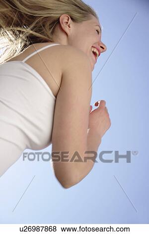 Young woman with long blond hair running at the beach, worm's eye view View Large Photo Image Stock Photo - Young woman with long blond hair running at the beach, worm's eye view. Fotosearch