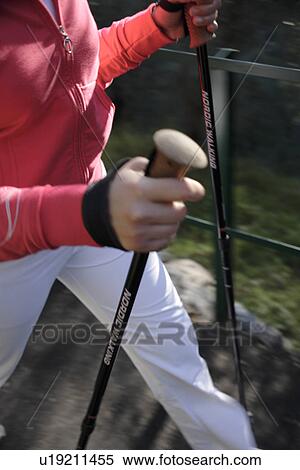 Stock Photography - Female Nordic walker, close up of hands and pole straps. Fotosearch