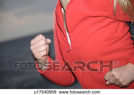 Upper part of woman's body jogging at the beach, side view View Large Photo Image Stock Photo - Upper part of woman's body jogging at the beach, side view. Fotosearch