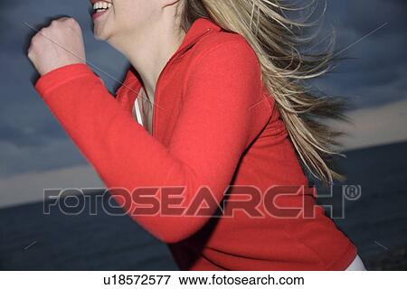 Upper part of woman's body jogging at the beach, side view View Large Photo Image Stock Photo - Upper part of woman's body jogging at the beach, side view. Fotosearch