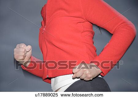 Upper part of woman's body jogging at the beach, side view View Large Photo Image Stock Photography - Upper part of woman's body jogging at the beach, side view. Fotosearch