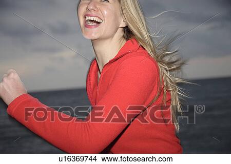 Young blond woman jogging at the beach, smiling View Large Photo Image Picture - Young blond woman jogging at the beach, smiling. Fotosearch