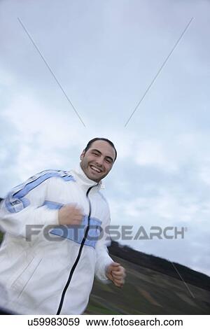 Young man jogging in spite of bad weather View Large Photo Image Stock Photo - Young man jogging in spite of bad weather. Fotosearch