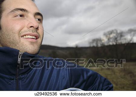 Young man jogging in sportswear, portrait View Large Photo Image Stock Photograph - Young man jogging in sportswear, portrait. Fotosearch