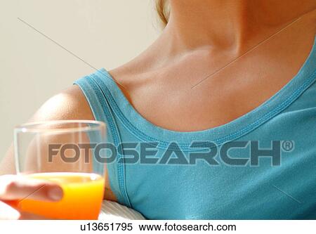 Female shoulder and hand holding glass of juice View Large Photo Image Stock Photography - Female shoulder and hand holding glass of juice. Fotosearch