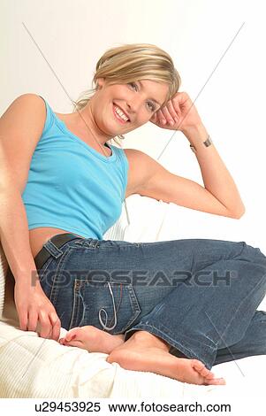 Stock Photography - Woman relaxing on sofa. Fotosearch