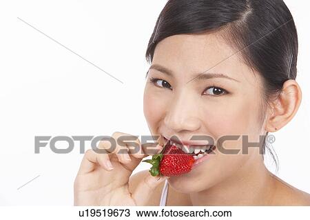 Portrait of Natural Young girl eating Strawberry View Large Photo Image Stock Image - Portrait of Natural Young girl eating Strawberry. Fotosearch