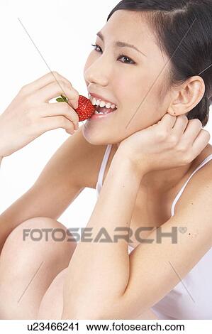 Portrait of Natural Young girl eating Strawberry View Large Photo Image Stock Image - Portrait of Natural Young girl eating Strawberry. Fotosearch