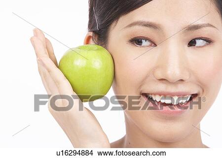 Portrait of Natural Young girl Holding Apple View Large Photo Image Picture - Portrait of Natural Young girl Holding Apple. Fotosearch