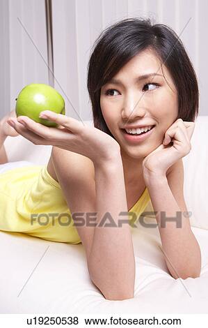 Portrait of Natural Young girl holding Apple, Smiling View Large Photo Image Stock Photo - Portrait of Natural Young girl holding Apple, Smiling. Fotosearch