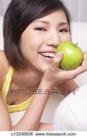 Portrait of Natural Young girl holding Apple, Smiling View Large Photo Image Stock Photograph - Portrait of Natural Young girl holding Apple, Smiling. Fotosearch