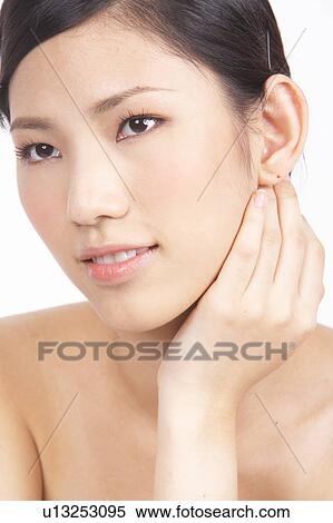 Stock Photography - Portrait of Natural Young girl with hands next to face. Fotosearch