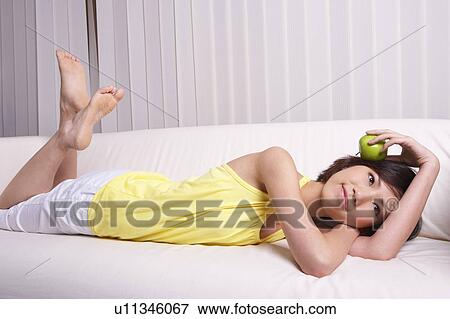 Young girl holding apple View Large Photo Image Stock Photo - Young girl holding apple. Fotosearch