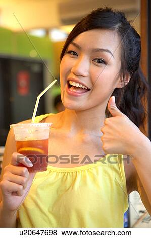 Young Lady Holding Cold Drink View Large Photo Image Stock Photo - Young Lady Holding Cold Drink. Fotosearch