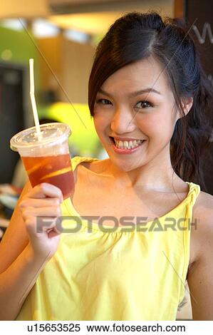 Stock Photography - Young Lady Holding Cold Drink. Fotosearch