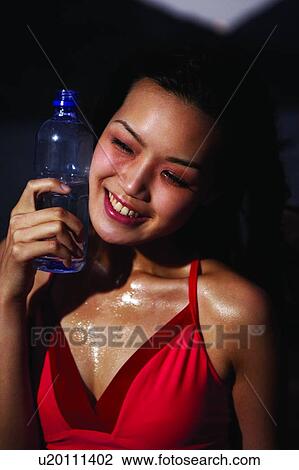 Young woman in sporty wear, standing near the sea, front view, close up View Large Photo Image Stock Image - Young woman in sporty wear, standing near the sea, front view, close up. Fotosearch