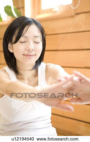 Stock Image - Woman stretching herself. Fotosearch