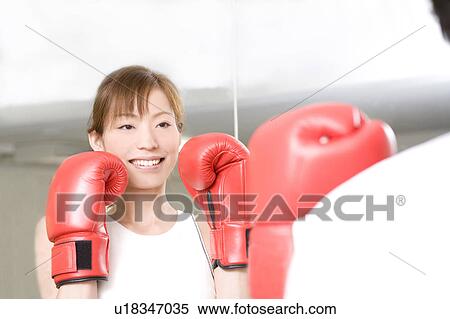 Stock Photography - Woman who does a boxing-exercise. Fotosearch