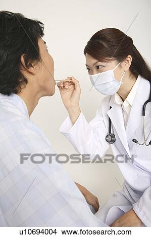 Picture - Doctor examining. Fotosearch
