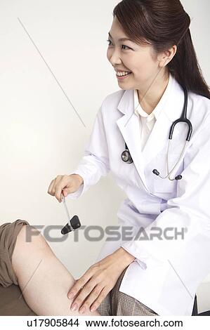 Doctor examining View Large Photo Image Picture - Doctor examining. Fotosearch